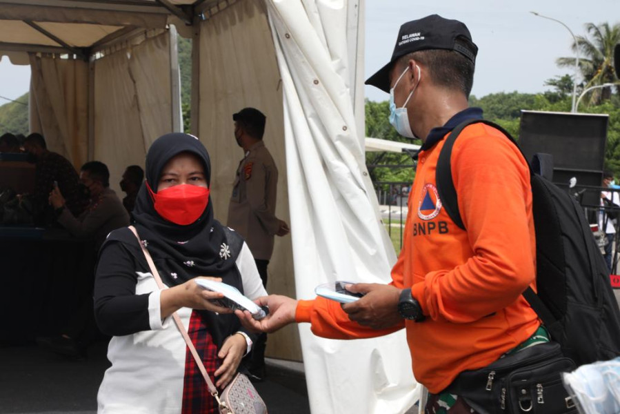 Pembagian paket protokol kesehatan (prokes) kepada para penonton MotoGP Mandalika di Gate 3 Pertamina Mandalika International Circuit, Lombok Tengah, Nusa Tenggara Barat, Minggu (20/3).